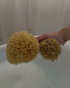 working up a rich lather with a sea sponge over a bath